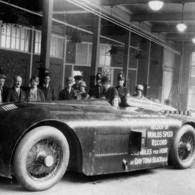 Landspeed car with people standing beside