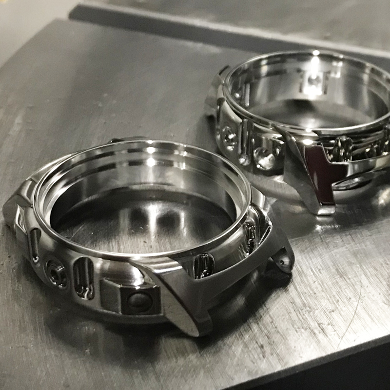 Two watch bodies on a table