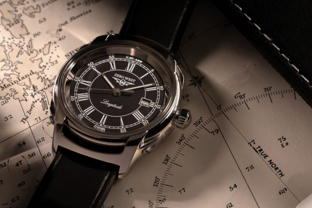 L2 watch with black leather strap on map