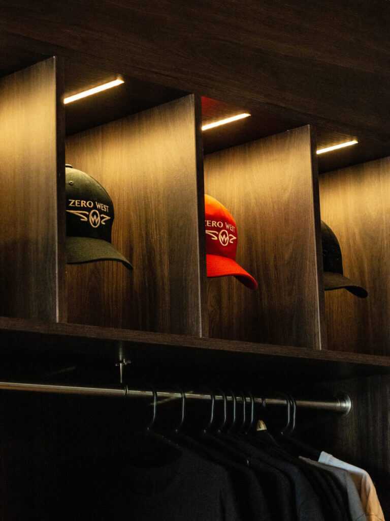Caps on display with tshirts hanging below