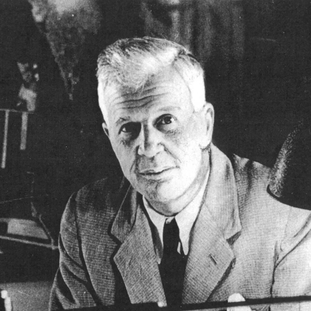 Black and white picture of Sir Barnes Wallis sitting at his desk