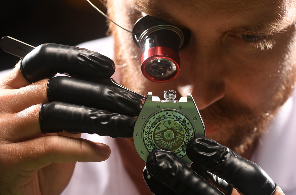 Watch builder examining LS2 watch