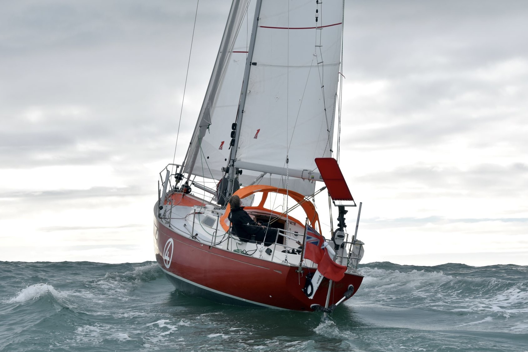 Red and white yacht sailing on the sea