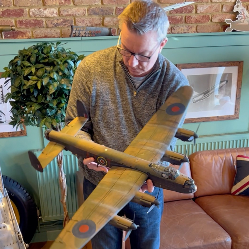 Man holding Dambuster model in zero west studio