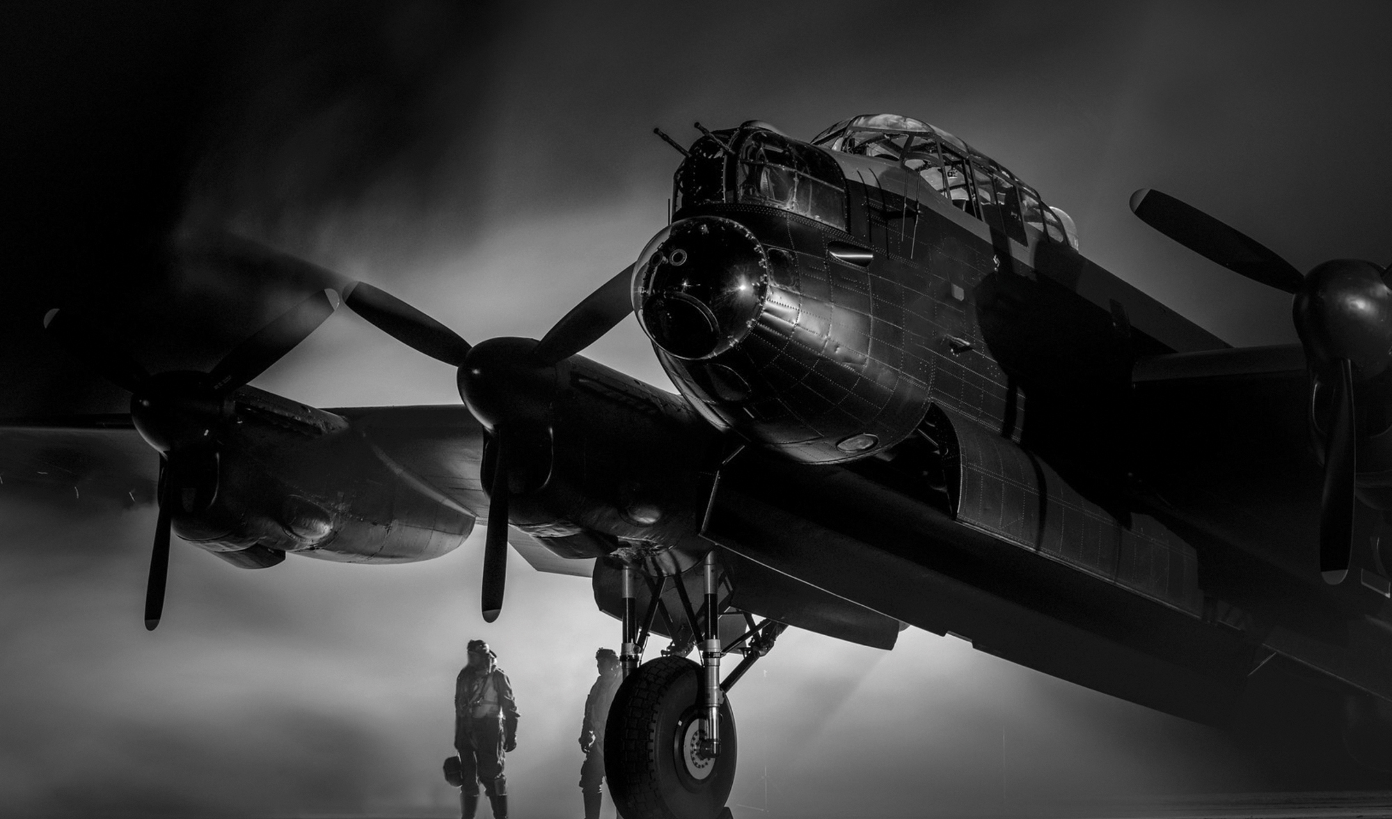 Lancaster bomber with two men beside