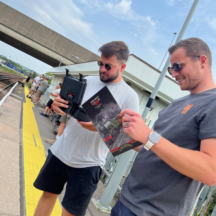Men at railway station looking at Flying Scotsman items